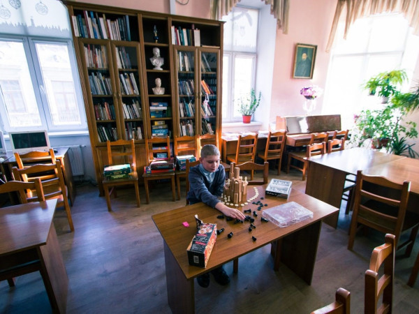 a person sitting at a table in a library