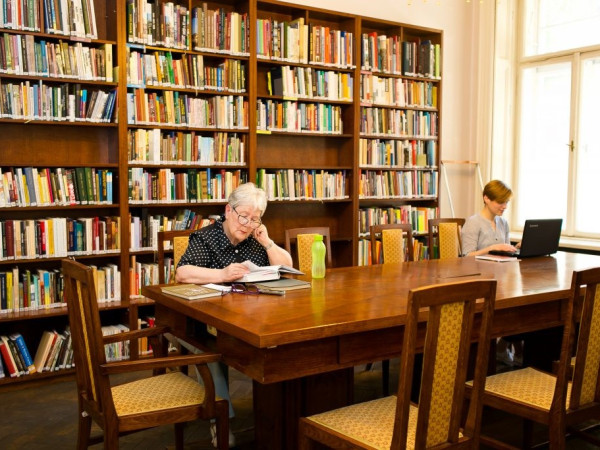 a few people studying in a library